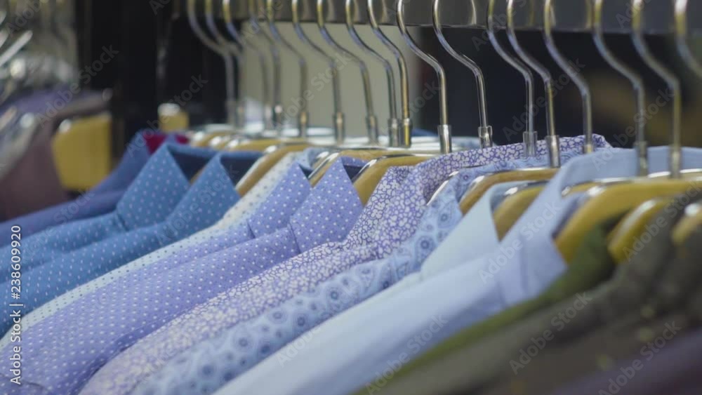 Men's shirts on hangers in wardrobe Men's shirts on hangers in wardrobe