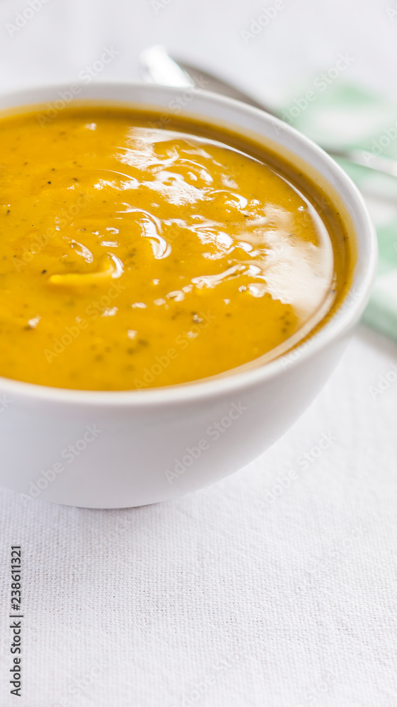 Close of white bowl with cabotia pumpkin soup Close of white bowl with cabotia pumpkin soup