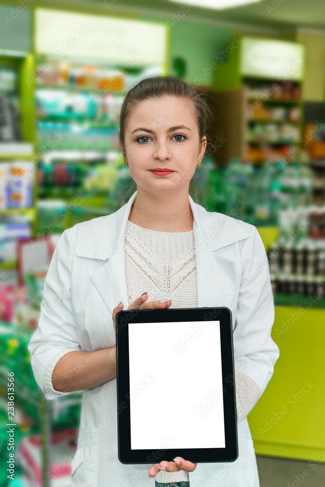 Attractive woman pharmacist showing tablet screen in drugstore
