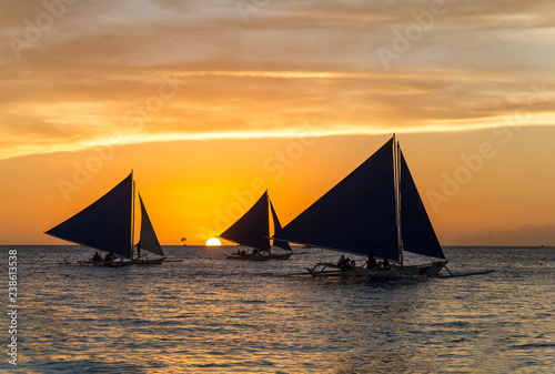 Small sailing boats at the sunset. Boracay, Philippines