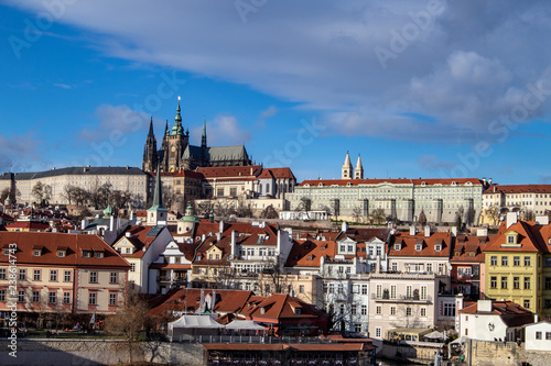 Prague, Czech Republic, Europe, panorama overlooking the historic buildings of Prague Castle, Charles Bridge and the Vltava River in front of interesting blue sky with clouds
