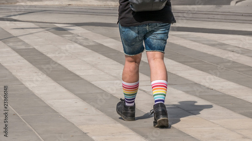 Men legs in colorful rainbow socks on street background, shot in Stockholm, Sweden, horizontal, copy space