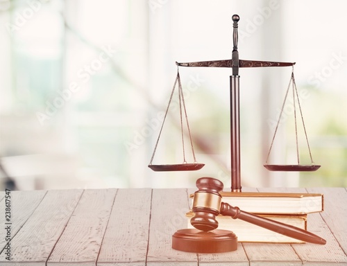 Justice Scales and books and gavel on wooden table