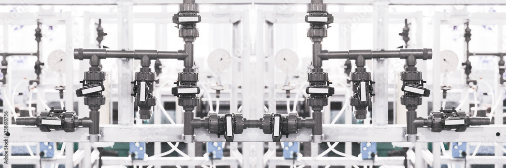 Closeup of process line in operation division of industrial facilities. Selective focus. Bleached image. Closeup of process line in operation division of industrial facilities. Selective focus. Bleached image.
