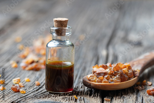 Murais de parede A bottle of myrrh essential oil with myrrh resin on a spoon