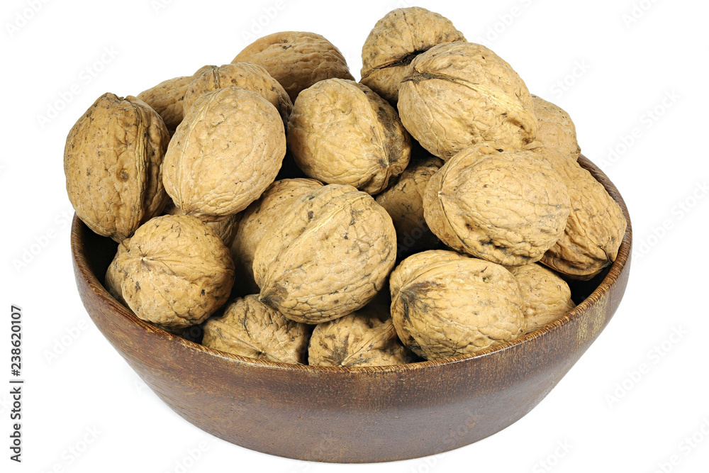 walnuts (variety Red Danube) in a wooden bowl isolated on white background walnuts (variety Red Danube) in a wooden bowl isolated on white background
