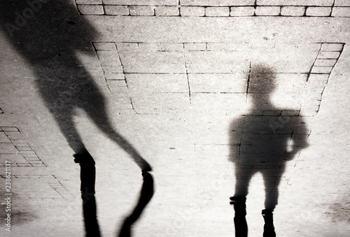 Blurry shadow silhouettes of two people