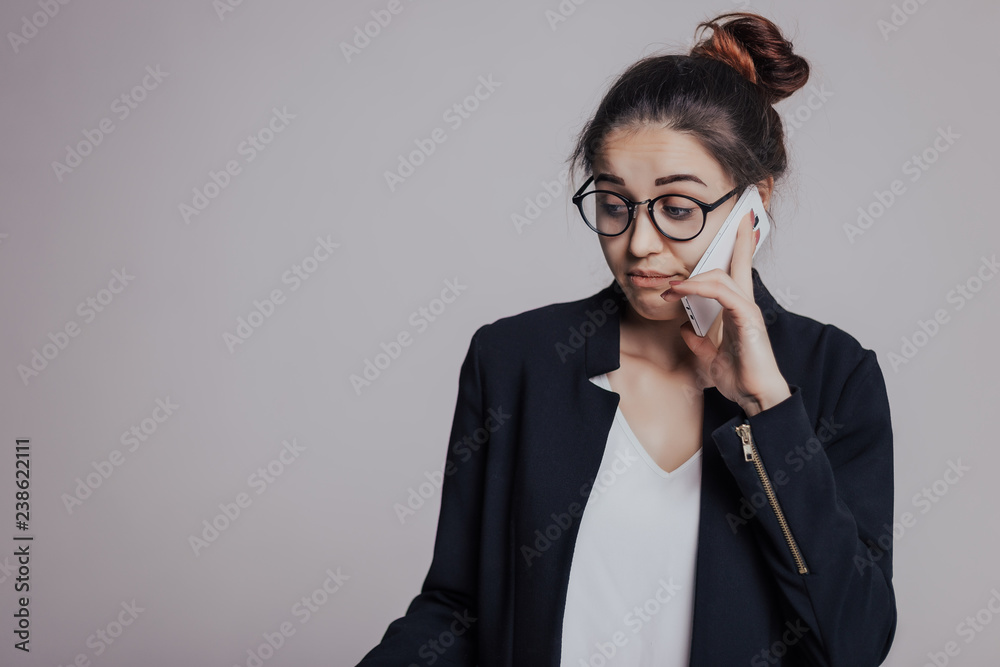 I am a little disappointed in you after hearing. The girl looks frustrated or confused when talking on the phone. Woman with mobile phone, in glasses and with hairstyle top knot I am a little disappointed in you after hearing. The girl looks frustrated or confused when talking on the phone. Woman with mobile phone, in glasses and with hairstyle top knot