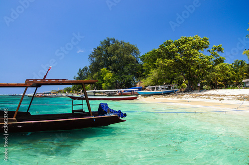 Sandy beach with azure water and boat Parking on the tropical island of Gili Air photo