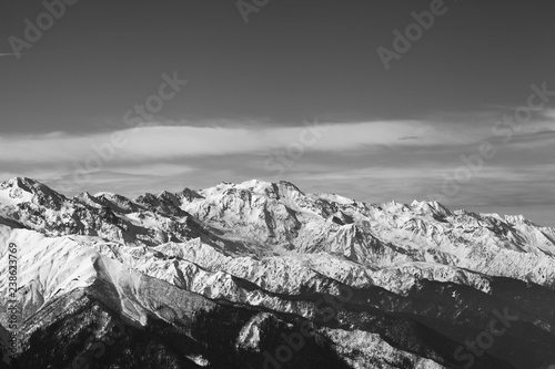 Black and white snowy mountains in nice sunny evening
