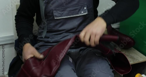 Shoe maker, master, craftsman, workman is manufacture, produce, make shoes in a small atelier. 