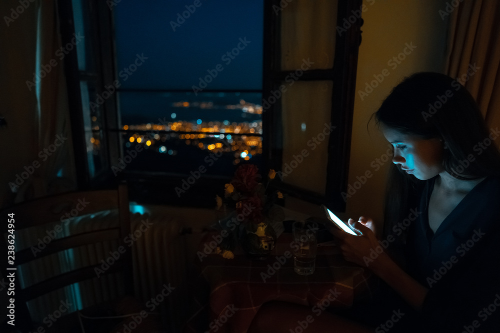 Woman using smart phone for online at home in evening