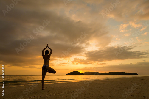 Girl practicing yoga Langkawi island photo