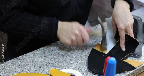 Woman working with leather at the table.Clicking for future shoes in the factory, footwear manufactory. 4K