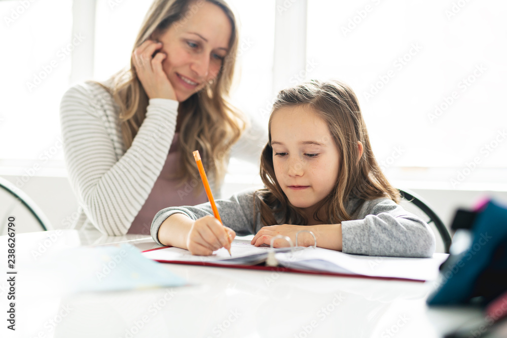 A Mother and Child doing homework at home A Mother and Child doing homework at home