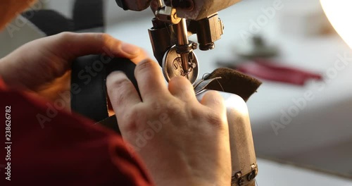 View of sewing machine for shoes. Woman s hand working at the factory with thread. 4K