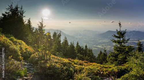 Sunset scenery on Smrk mountain in Moravskoslezske Beskydy in Czech republic with clear sky and only few clouds during late summer with Ondrejnik and Radhost