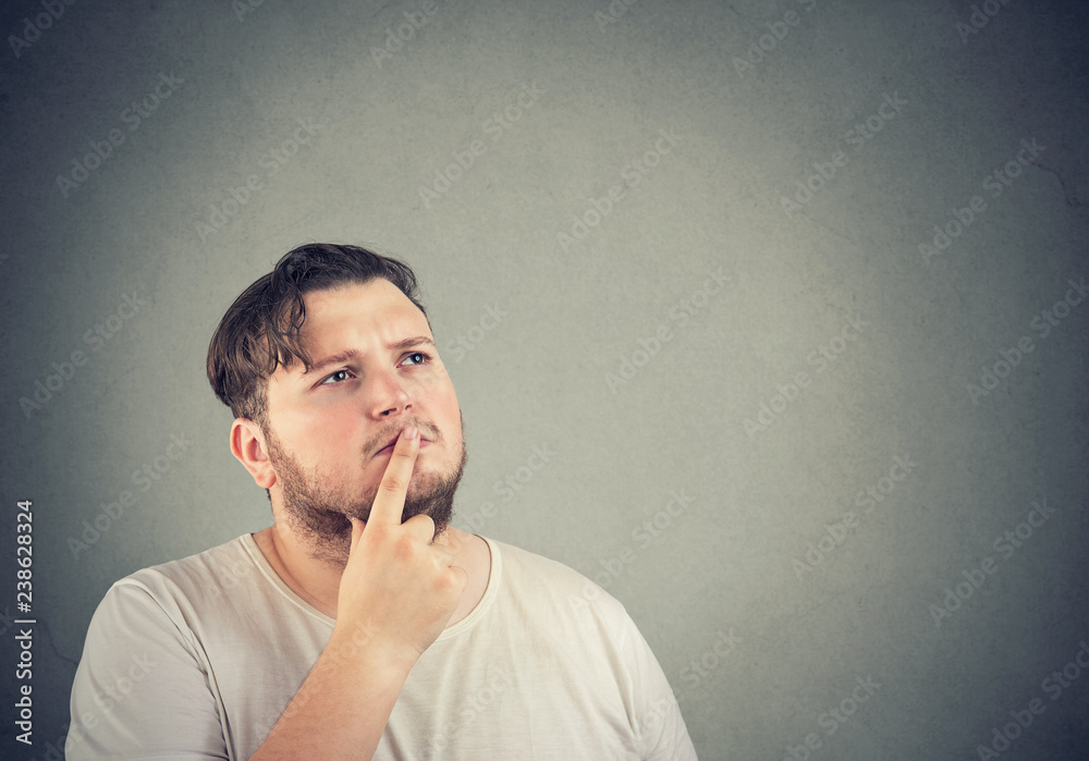 Pensive man touching lips while remembering Pensive man touching lips while remembering