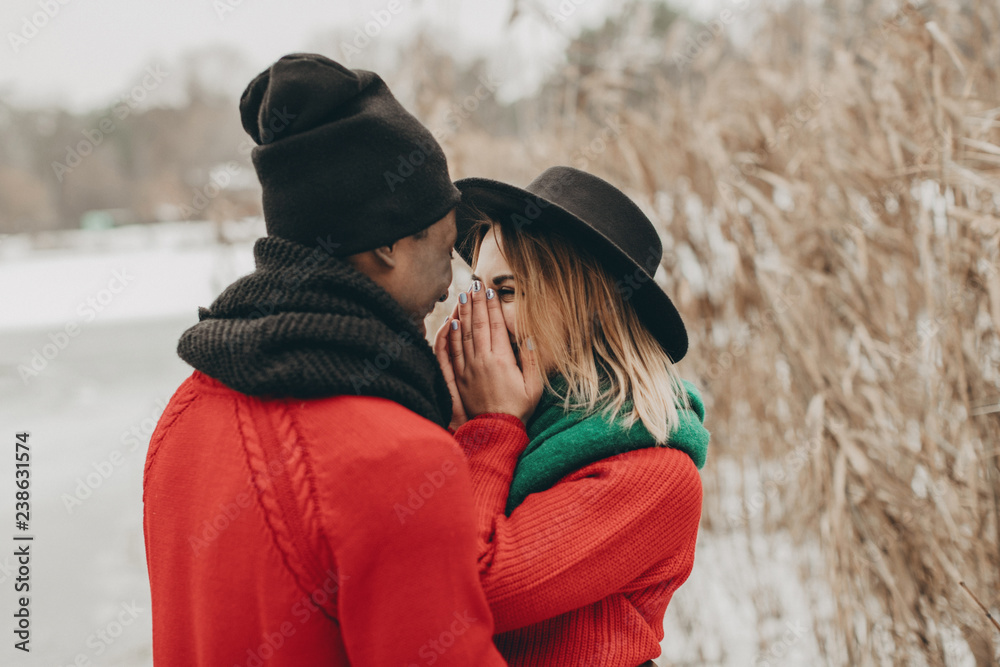 young couple in love walks through the winter forest and kiss young couple in love walks through the winter forest and kiss