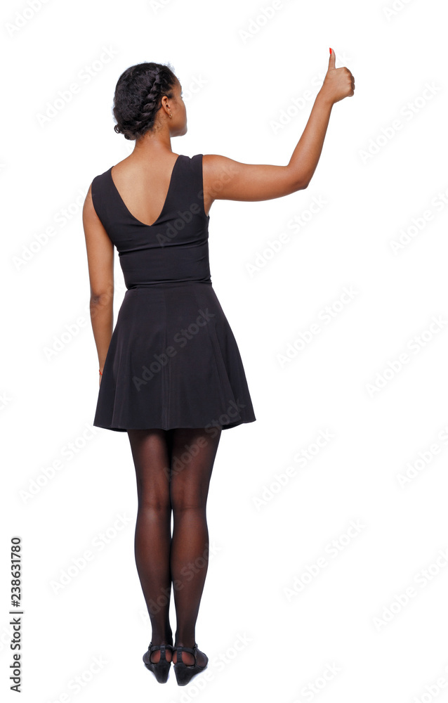 Fototapeta premium Back view of a black woman showing thumb up.