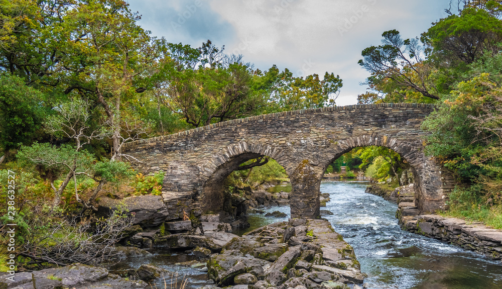 Old Weir Bridge, Meeting of the Waters, where the three Killarney lakes (Upper, Muckross and Lough Lane) meet Killarney National Park, County Kerry, Ireland. Old Weir Bridge, Meeting of the Waters, where the three Killarney lakes (Upper, Muckross and Lough Lane) meet Killarney National Park, County Kerry, Ireland.