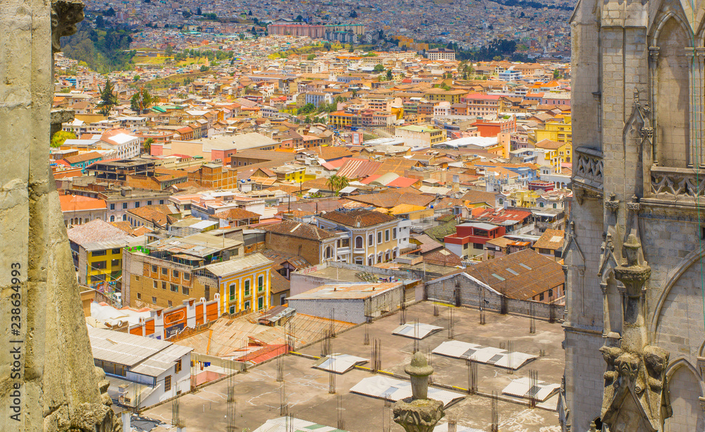 Top view of rooftops of the colonial town with some colonial houses located in the city of Quito