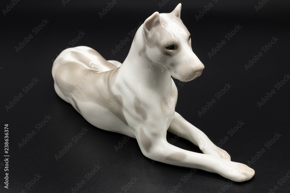 Φωτογραφία Antique porcelain figurine of a dog Deutsche Dogge breed on the black background