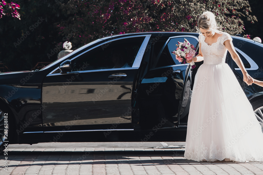 Happy bride and groom in a black car on wedding day Stock Photo | Adobe ...