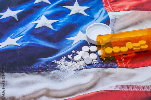 Opioid and drug addiction epidemic concept in United States with pills and bottle and room for copy text