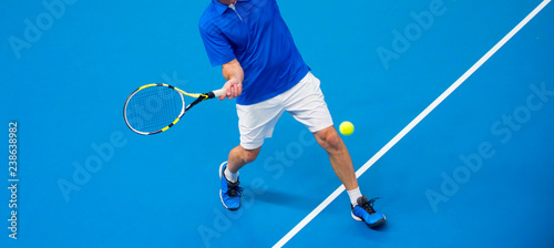 man playing tennis on blue floor © Augustas Cetkauskas