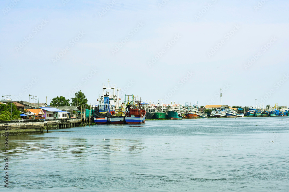 Many colorful cargo and passenger boat park on the river, Wooden ship on riverside port