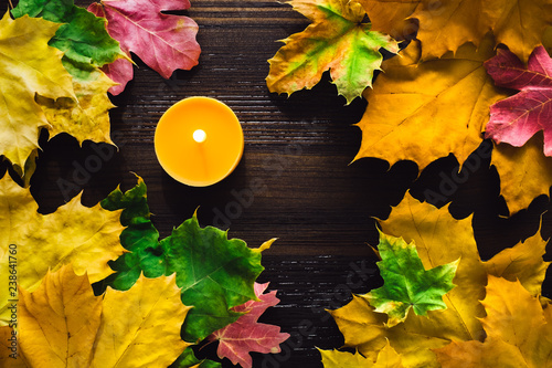 Autumn Leaves with Lit Orange Candle photo