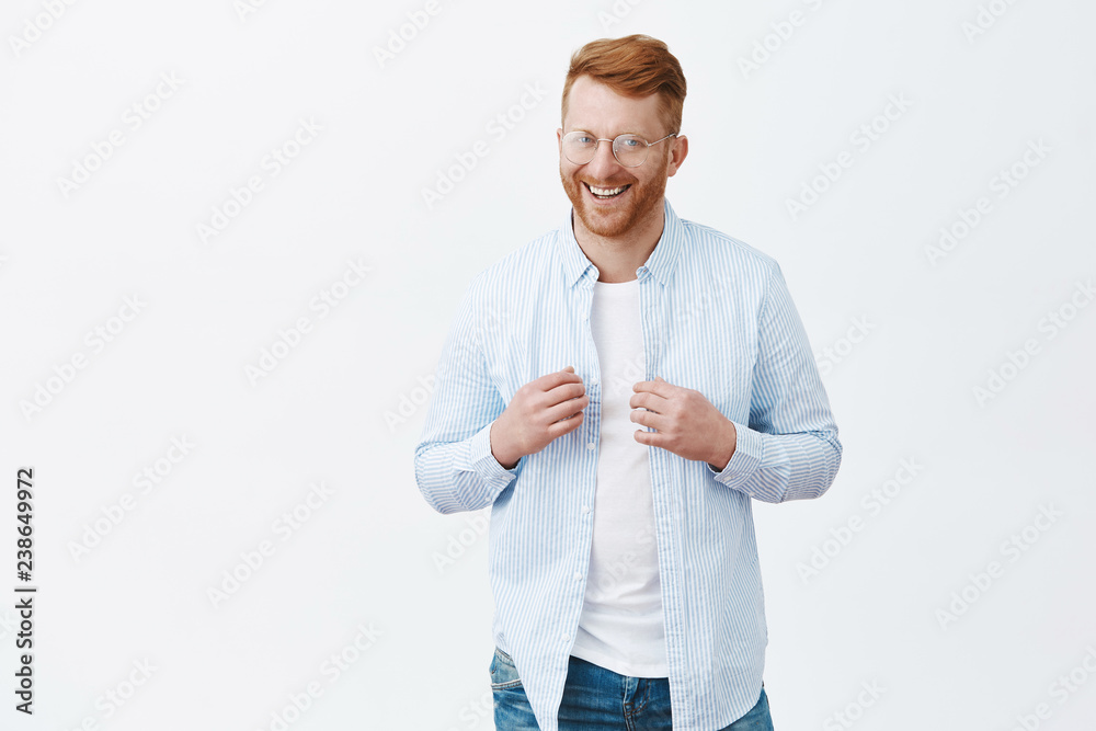 Sure he will get what want. Portrait of confident and happy handsome redhead guy with bristle, touching shirt with self-assured and uplifted expression, smiling broadly, getting ready to go out Sure he will get what want. Portrait of confident and happy handsome redhead guy with bristle, touching shirt with self-assured and uplifted expression, smiling broadly, getting ready to go out
