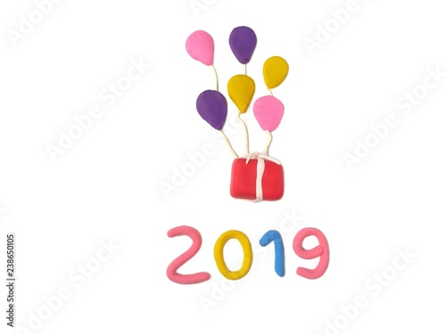 Red gift box floating in the sky with colorful balloon and number 2019 year text are handmade from plasticine clay on white background  cute shape are dough 