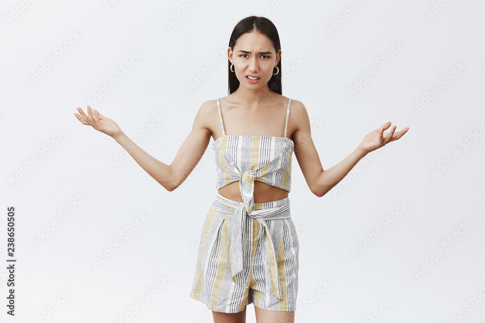 Who did all mess. Portrait of displeased annoyed and bossy confident woman in matched top and shirts, shrugging with spread palms with intense pissed expression, clueless and disappointed Who did all mess. Portrait of displeased annoyed and bossy confident woman in matched top and shirts, shrugging with spread palms with intense pissed expression, clueless and disappointed