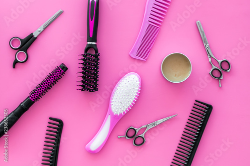 combs for hairdresser hairdresser on pink background top view