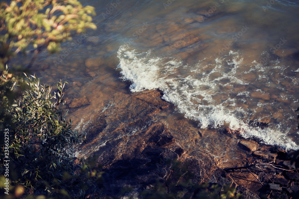 Wave crashing on shore rocks Wave crashing on shore rocks