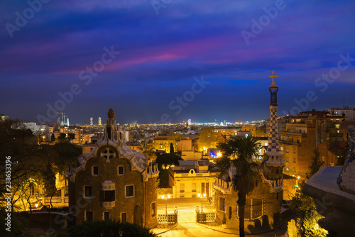 Park Guell in Barcelona, Spain at night. Barcelona skyline..