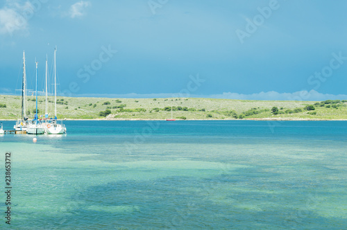 yachts moored in the harbor of Fornells, with a blue sea in summer day, Menorca, Balearic Islands.