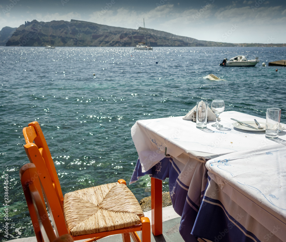 Outdoor restaurant chair and table on the coast of Santorini Island; Greece