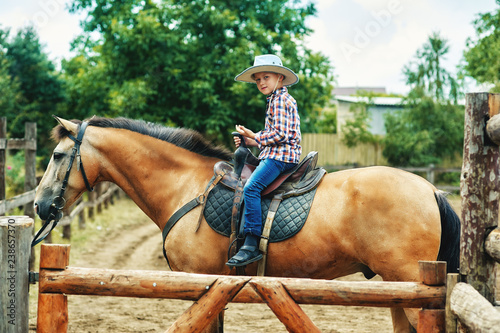 boy riding a horse . children's ranch holidays