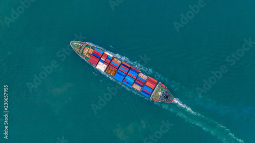 Aerial view container ship carrying container for import and export, business logistic and freight transportation by ship in open sea.