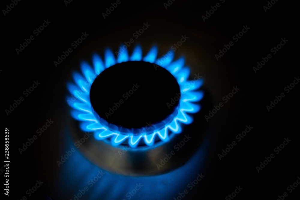 Natural gas burning a blue flames on black background at home Natural gas burning a blue flames on black background at home