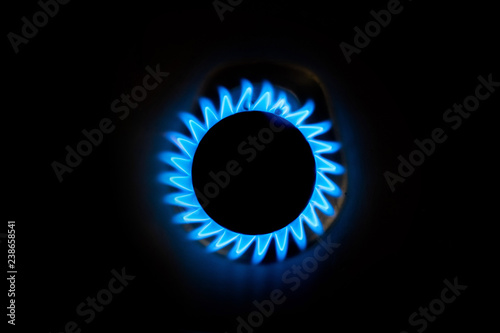 Natural gas burning a blue flames on black background at home