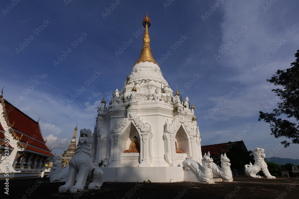 White Lion Statue with white pagoda of the temple of Thailand
