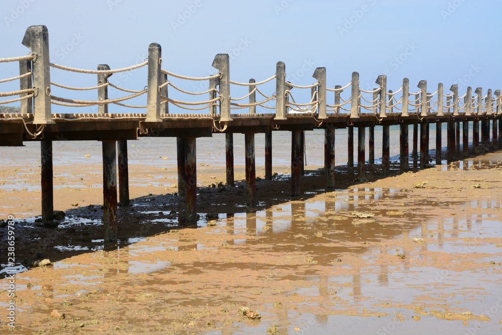 wooden bridge on the sea in a resort area