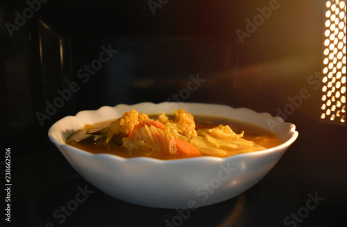 Look inside the microwave food white bowl, In a warm atmosphere and empty top space for text. (Spicy food). Non color ceramic applicable to available with microwave.