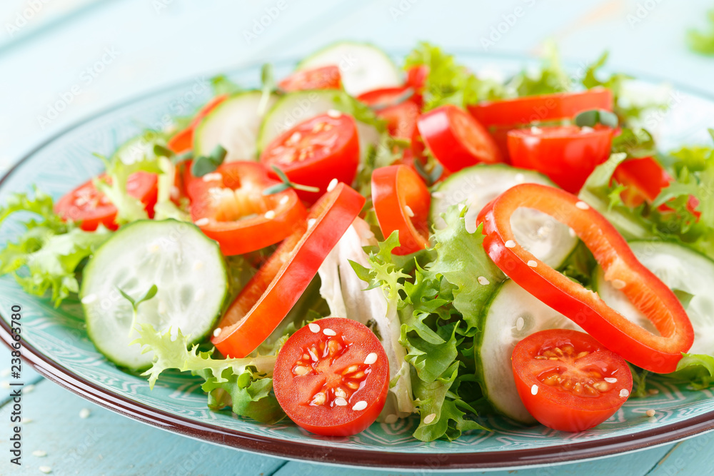 Healthy vegetarian vegetable salad of fresh lettuce, cucumber, sweet pepper and tomatoes. Vegan plant-based food. Flat Lay. Top view Healthy vegetarian vegetable salad of fresh lettuce, cucumber, sweet pepper and tomatoes. Vegan plant-based food. Flat Lay. Top view