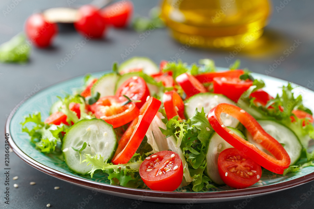 Healthy vegetarian vegetable salad of fresh lettuce, cucumber, sweet pepper and tomatoes. Vegan plant-based food. Flat Lay. Top view