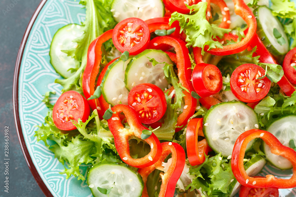 Healthy vegetarian vegetable salad of fresh lettuce, cucumber, sweet pepper and tomatoes. Vegan plant-based food. Flat Lay. Top view Healthy vegetarian vegetable salad of fresh lettuce, cucumber, sweet pepper and tomatoes. Vegan plant-based food. Flat Lay. Top view